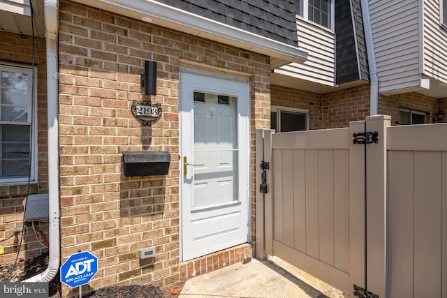2193 Harbour Dr, Palmyra, NJ 08065 - property entrance with brick siding, a gate, and mansard roof