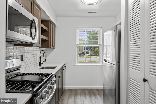 2193 Harbour Dr, Palmyra, NJ 08065 - kitchen with stainless steel appliances, light wood finished floors, tasteful backsplash, and light countertops