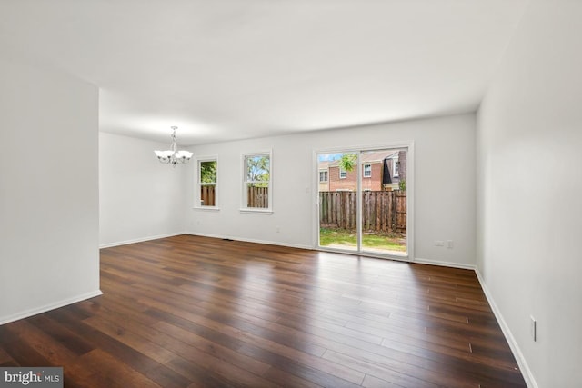 70 Oak Shade Rd, Gaithersburg, MD 20878 - spare room with a chandelier, healthy amount of natural light, and dark wood finished floors