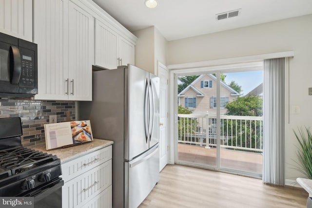 622 Main St Unit 622B, Gaithersburg, MD 20878 - kitchen with black appliances, decorative backsplash, light wood finished floors, light stone counters, and white cabinets