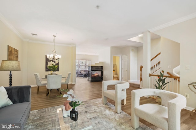 622 Main St Unit 622B, Gaithersburg, MD 20878 - living room with wood finished floors, stairway, a chandelier, a multi sided fireplace, and ornamental molding