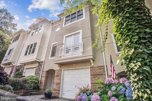 3818 White Post Ct, Alexandria, VA 22304 - view of property featuring a garage, brick siding, and stucco siding