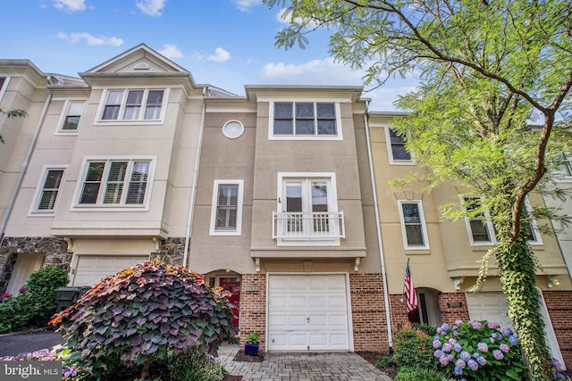 3818 White Post Ct, Alexandria, VA 22304 - view of property featuring a garage, stucco siding, and driveway
