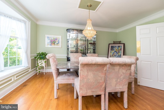 760 Audubon Dr, North Wales, PA 19454 - dining area featuring a chandelier, light wood-type flooring, and crown molding