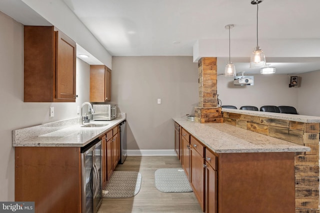 29 Carrington Way, Marlton, NJ 08053 - kitchen with beverage cooler, a peninsula, light wood finished floors, brown cabinetry, and light stone countertops