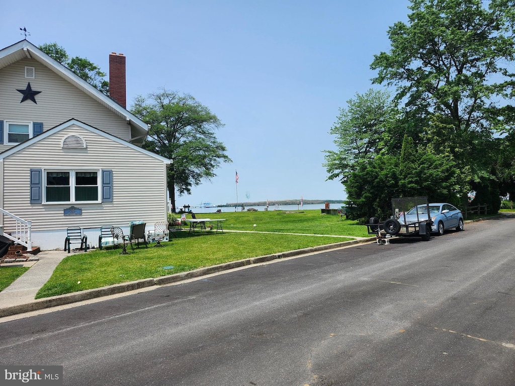 15 Spring St, Penns Grove, NJ 08069 - view of side of home featuring a chimney, a lawn, and a water view