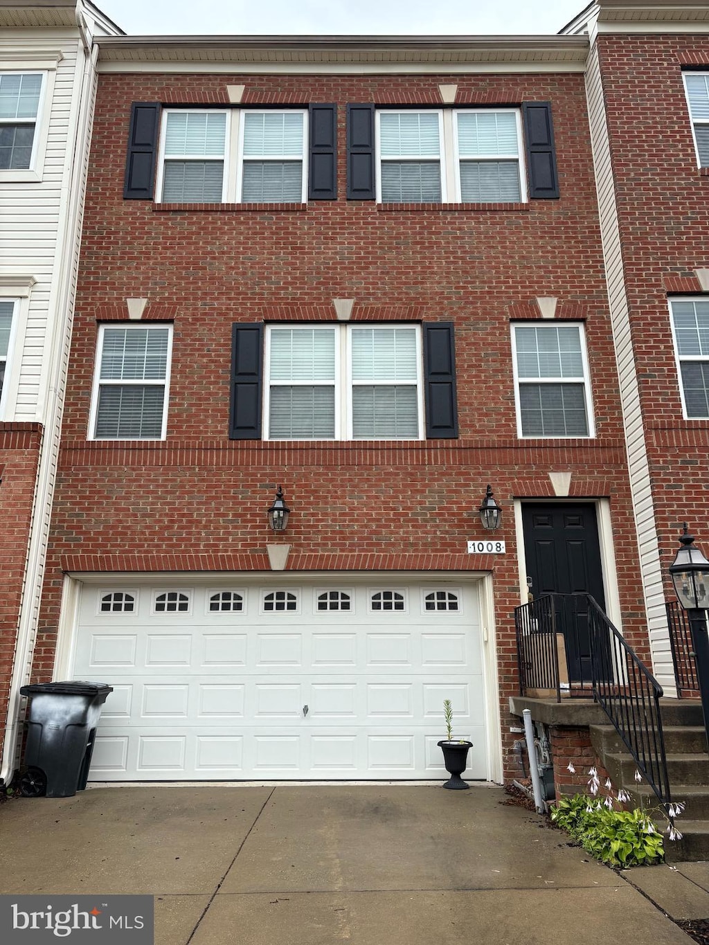 1008 Red Clover Rd, Gambrills, MD 21054 - multi unit property featuring concrete driveway, an attached garage, and brick siding