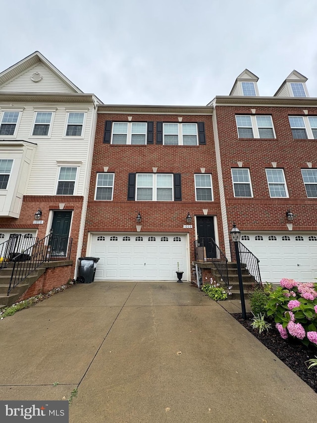 1008 Red Clover Rd, Gambrills, MD 21054 - townhome / multi-family property with concrete driveway, an attached garage, and brick siding