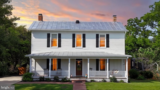 12353 Barbee Rd, Bristow, VA 20136 - view of front of property featuring a standing seam roof, a porch, a lawn, a chimney, and a metal roof