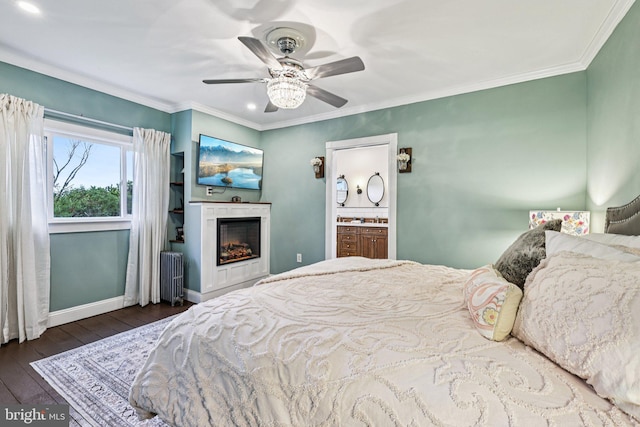 12353 Barbee Rd, Bristow, VA 20136 - bedroom featuring radiator heating unit, hardwood / wood-style floors, ornamental molding, a warm lit fireplace, and a ceiling fan