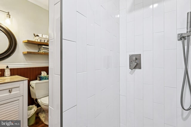 12353 Barbee Rd, Bristow, VA 20136 - bathroom featuring a tile shower, wainscoting, and vanity