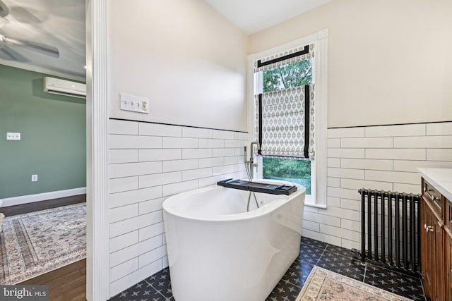 12353 Barbee Rd, Bristow, VA 20136 - full bath with tile walls, a freestanding bath, an AC wall unit, vanity, and ceiling fan