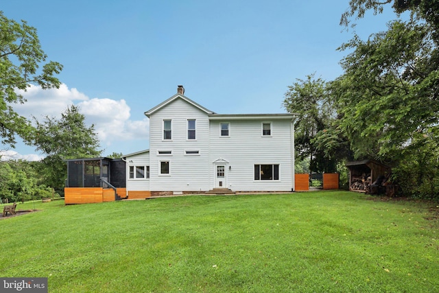12353 Barbee Rd, Bristow, VA 20136 - back of property with a sunroom, a lawn, entry steps, and a chimney