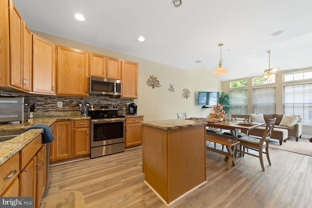 10112 Collington Campus Dr Unit 7, Bowie, MD 20721 - kitchen with appliances with stainless steel finishes, decorative backsplash, a ceiling fan, a center island, and light wood-type flooring