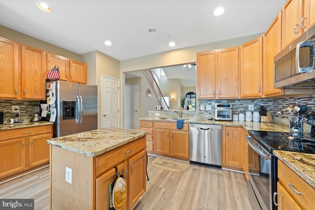 10112 Collington Campus Dr Unit 7, Bowie, MD 20721 - kitchen featuring appliances with stainless steel finishes, light wood finished floors, backsplash, recessed lighting, and light stone countertops