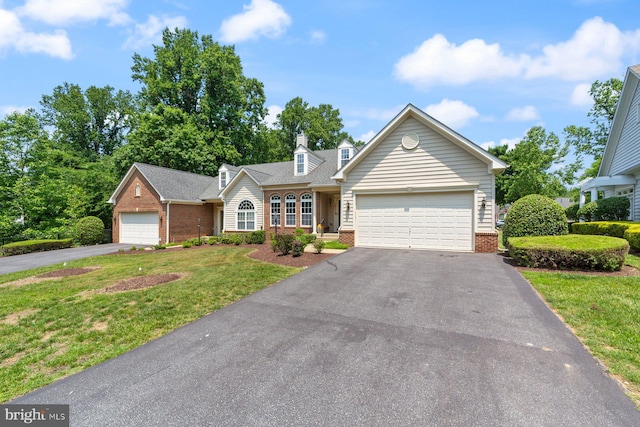 10112 Collington Campus Dr Unit 7, Bowie, MD 20721 - view of front facade with brick siding, asphalt driveway, a front lawn, an attached garage, and a shingled roof
