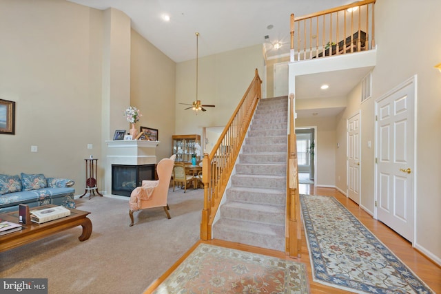 10112 Collington Campus Dr Unit 7, Bowie, MD 20721 - stairs featuring a towering ceiling, a glass covered fireplace, and ceiling fan