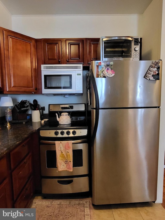 224 W Rittenhouse Sq Unit 3118, Philadelphia, PA 19103 - kitchen with stainless steel appliances, light tile patterned flooring, and dark stone countertops