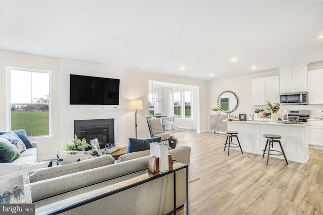 20 Hidden Brook Blvd, Dover, DE 19904 - living area with light wood-style floors, recessed lighting, and a large fireplace