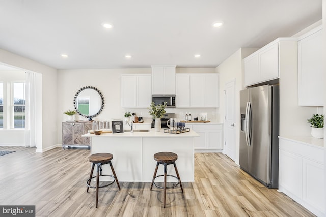 20 Hidden Brook Blvd, Dover, DE 19904 - kitchen featuring stainless steel appliances, a kitchen breakfast bar, light wood-type flooring, white cabinets, and recessed lighting