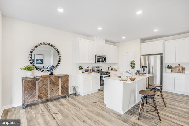 20 Hidden Brook Blvd, Dover, DE 19904 - kitchen with stainless steel appliances, a breakfast bar, light wood-type flooring, and recessed lighting