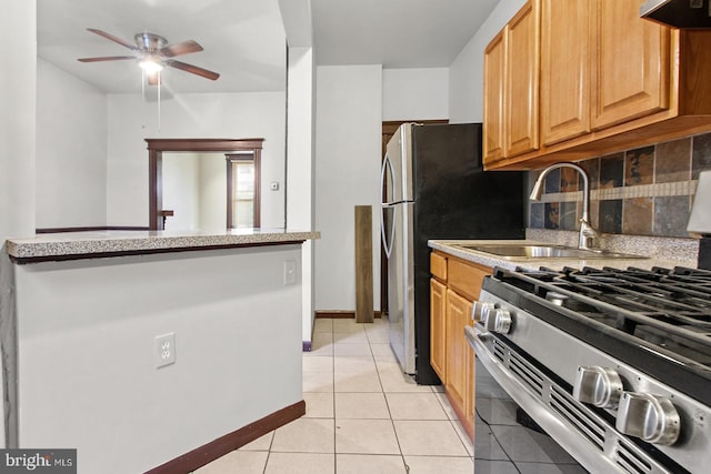 2904 N Taney St, Philadelphia, PA 19132 - kitchen with stainless steel range with gas cooktop, a ceiling fan, light tile patterned floors, extractor fan, and light countertops