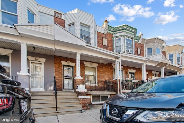 2904 N Taney St, Philadelphia, PA 19132 - view of front of property with brick siding, a porch, and cooling unit