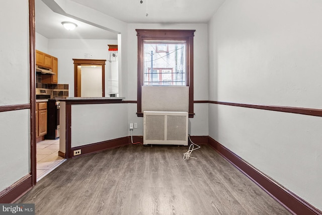 2904 N Taney St, Philadelphia, PA 19132 - unfurnished dining area featuring radiator heating unit and light wood-style floors