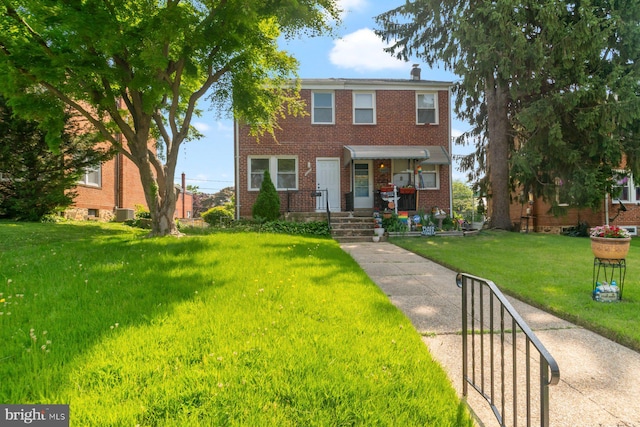 3920 Wilke Ave, Baltimore, MD 21206 - view of property with brick siding, a front yard, and a chimney
