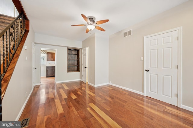 211 Dawson St, Philadelphia, PA 19128 - unfurnished living room with a ceiling fan, wood finished floors, stairway, and built in shelves