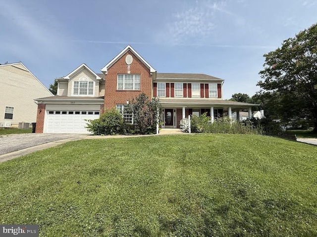 1912 Hampshire Dr, Hyattsville, MD 20783 - colonial home featuring a garage, asphalt driveway, a front lawn, brick siding, and covered porch
