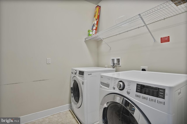 1220 Main Line Blvd Unit 102, Alexandria, VA 22301 - laundry room with baseboards and washer and clothes dryer