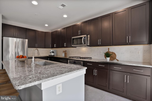 1220 Main Line Blvd Unit 102, Alexandria, VA 22301 - kitchen with appliances with stainless steel finishes, light stone counters, a breakfast bar area, backsplash, and recessed lighting