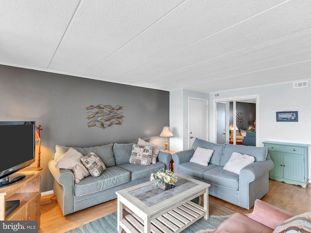 107 Convention Center Dr Unit 1410D, Ocean City, MD 21842 - living area with light wood finished floors and a textured ceiling
