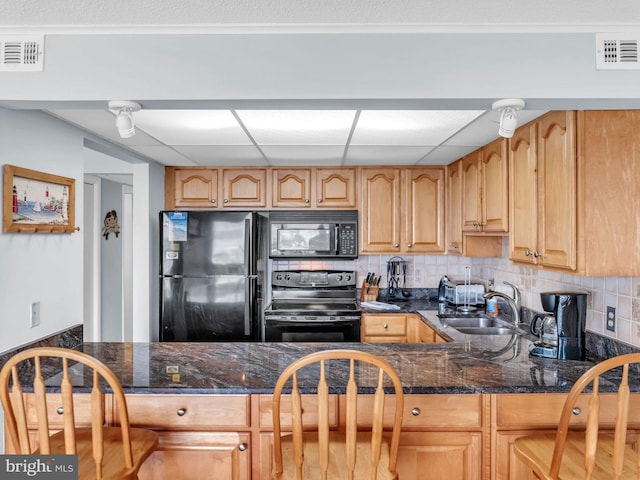 107 Convention Center Dr Unit 1410D, Ocean City, MD 21842 - kitchen with black appliances, backsplash, a drop ceiling, dark stone counters, and a peninsula