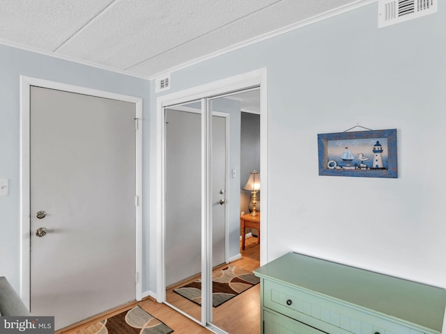 107 Convention Center Dr Unit 1410D, Ocean City, MD 21842 - doorway to outside featuring light wood-style floors, crown molding, and a textured ceiling