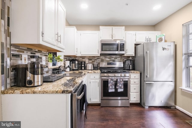 6571 Ronald Rd, Capitol Heights, MD 20743 - kitchen featuring appliances with stainless steel finishes, white cabinetry, tasteful backsplash, light stone counters, and recessed lighting