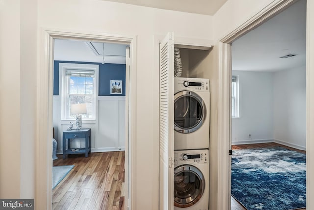 2806 S Abingdon St Unit A, Arlington, VA 22206 - washroom with stacked washing machine and dryer, attic access, wood finished floors, wainscoting, and a decorative wall