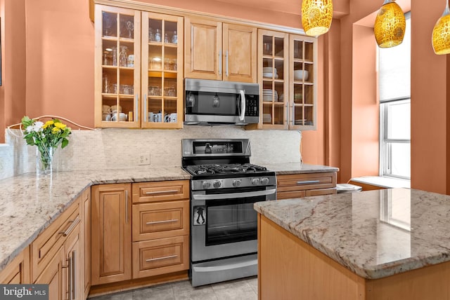 1518 Mount Vernon St Unit 3, Philadelphia, PA 19130 - kitchen with stainless steel appliances, tasteful backsplash, and light stone counters