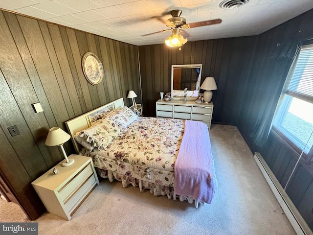 3434 Willow St, Chincoteague Island, VA 23336 - bedroom with a baseboard radiator, wood walls, carpet, and ceiling fan