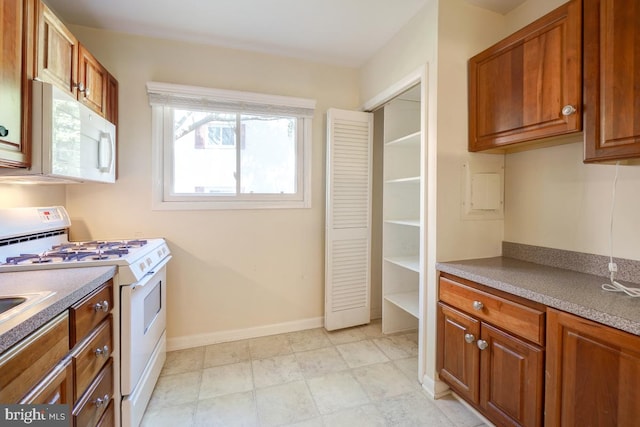 53 Skyhill Rd Unit 204, Alexandria, VA 22314 - kitchen featuring white appliances and brown cabinets