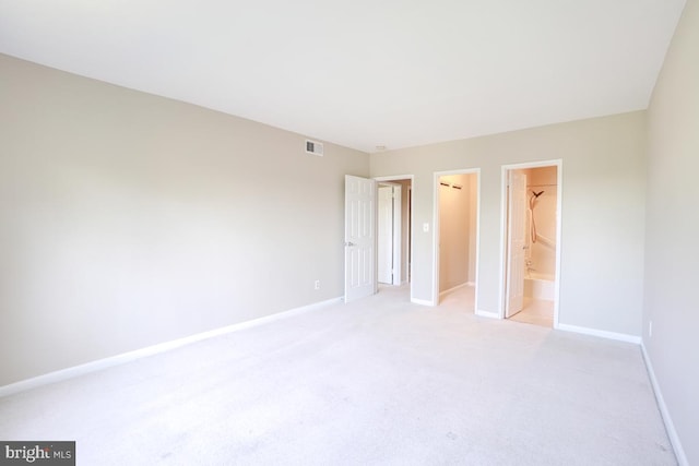 53 Skyhill Rd Unit 204, Alexandria, VA 22314 - unfurnished bedroom featuring light carpet, a walk in closet, and a closet