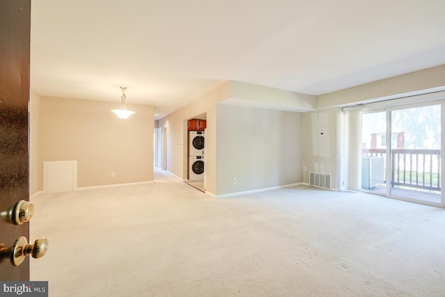 53 Skyhill Rd Unit 204, Alexandria, VA 22314 - carpeted empty room featuring estacked washer and dryer and baseboards