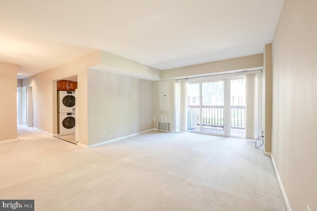 53 Skyhill Rd Unit 204, Alexandria, VA 22314 - spare room featuring stacked washer / dryer and light carpet