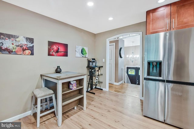 6614 Mccahill Dr, Laurel, MD 20707 - kitchen featuring stainless steel fridge, light wood-type flooring, recessed lighting, a chandelier, and brown cabinetry
