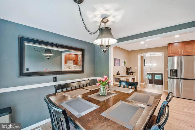 6614 Mccahill Dr, Laurel, MD 20707 - dining space with a chandelier, light wood finished floors, recessed lighting, and arched walkways