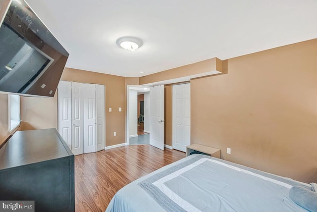 6614 Mccahill Dr, Laurel, MD 20707 - bedroom featuring two closets and wood finished floors