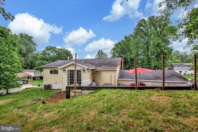 6614 Mccahill Dr, Laurel, MD 20707 - rear view of house featuring a lawn