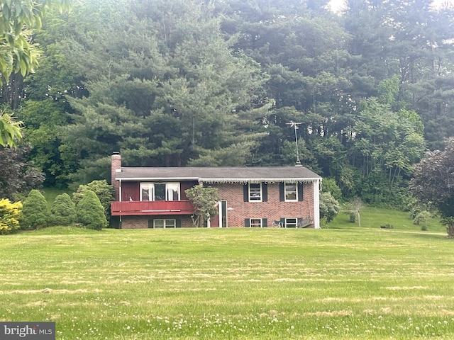 4704 Baughman Ml, Manchester, MD 21102 - bi-level home featuring a front lawn, a chimney, a deck, and a forest view