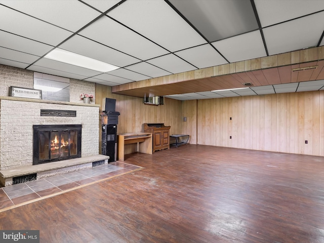 4704 Baughman Ml, Manchester, MD 21102 - unfurnished living room featuring a drop ceiling, a fireplace, wood finished floors, and wood walls